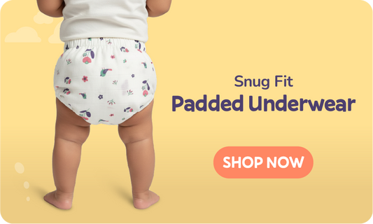 Child wearing a patterned snug fit cotton reusable padded underwear with a 'Shop Now' button on a yellow background